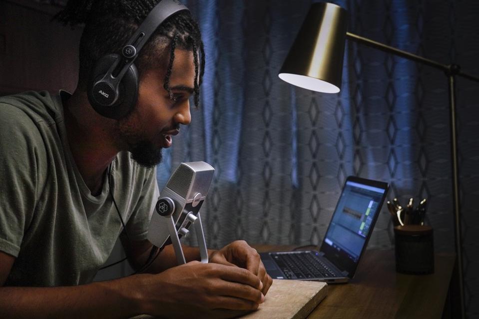 Man talking into AKG Lyra sitting at a desk